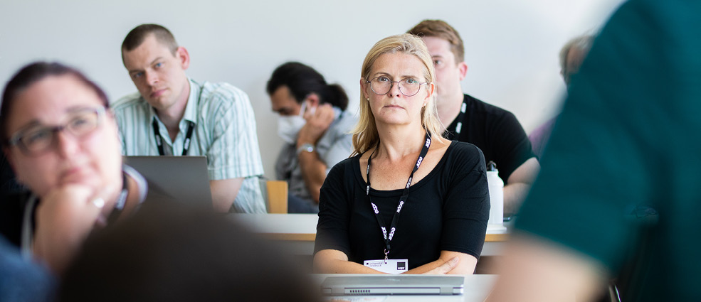 Group of people listening during a Panel session looking toward the speaker